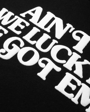 
                  
                    Load image into Gallery viewer, AIN&amp;#39;T WE LUCKY! T-SHIRT (BLACK)
                  
                